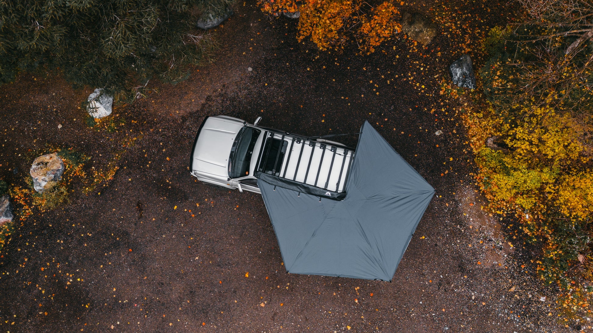 Birdseye, drone shot from above showing the entire 270 degree free standing awning set up and extended