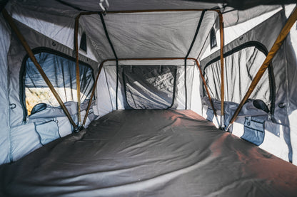 Interior shot of Soft shell rooftoptent, showing large mattress, pockets and sealable windows